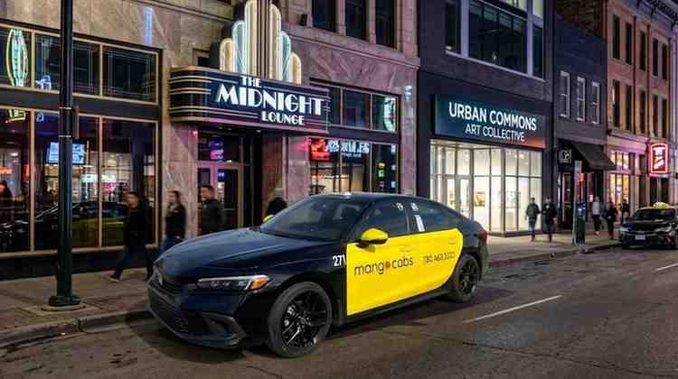 A black and yellow Mango Cabs vehicle parked safely along a bustling downtown street at night, illuminated by neon signs including "The Midnight Lounge" and "Urban Commons.